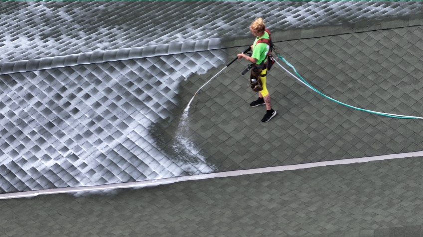 Worker applying roof rejuvenation treatment- Roof Rejuvenate pros